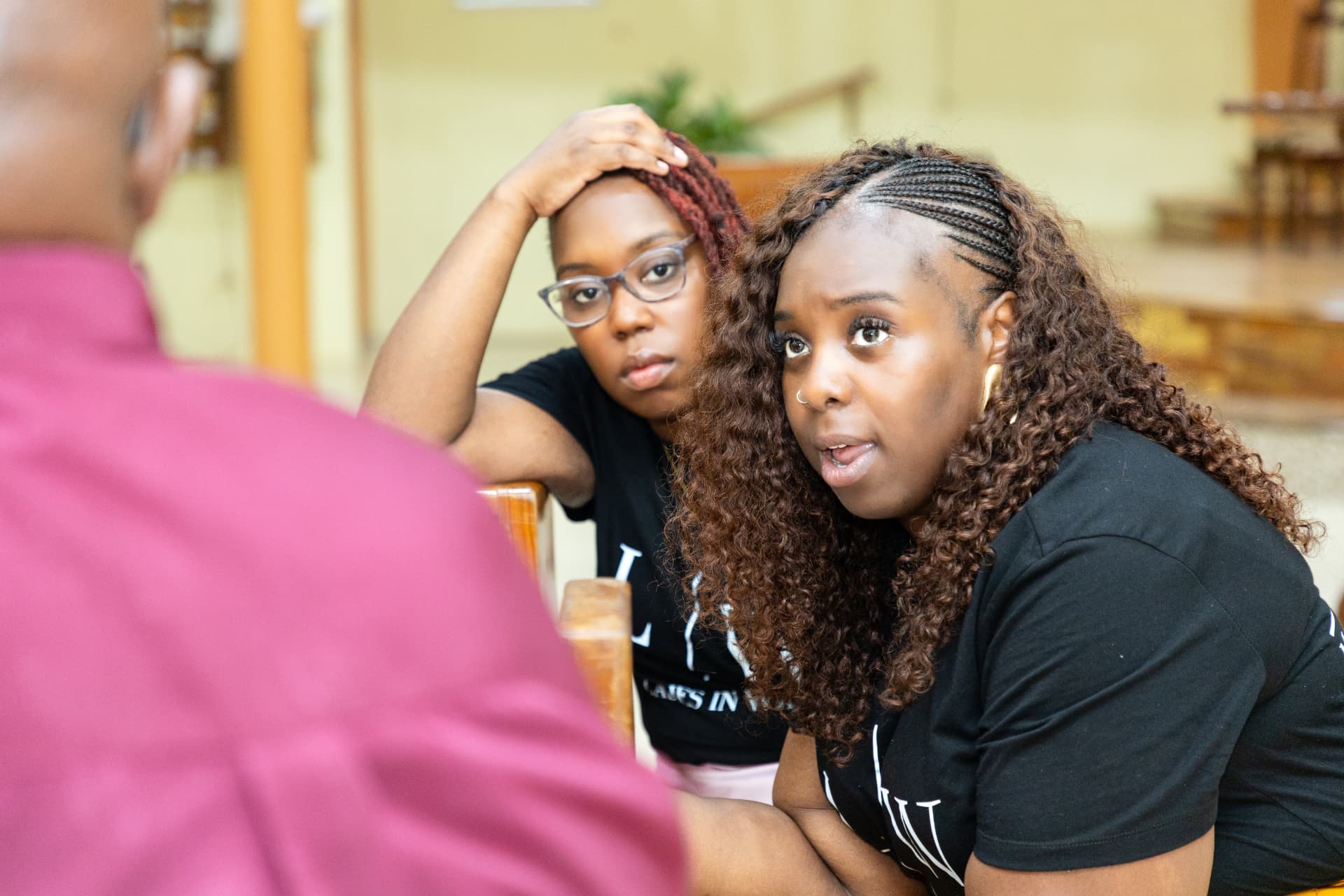 LIW Jamaica team members in branded T-shirts talking with a guest