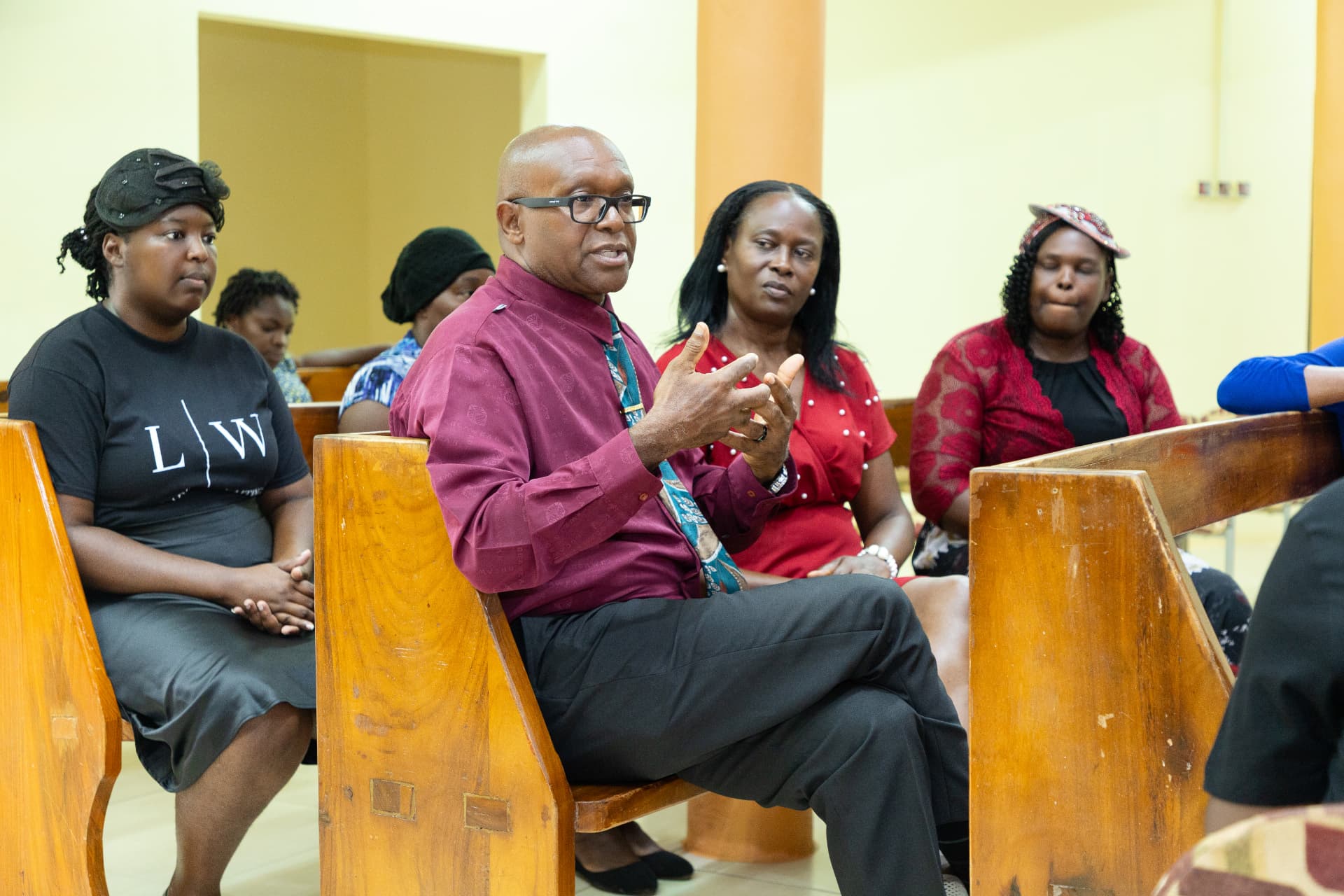 A community leader speaking during the launch discussion while attendees listen