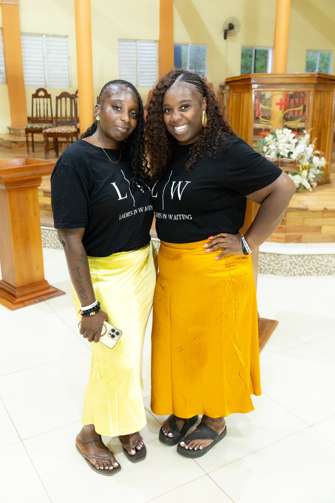 Two LIW Jamaica volunteers smiling together in branded T-shirts at the launch