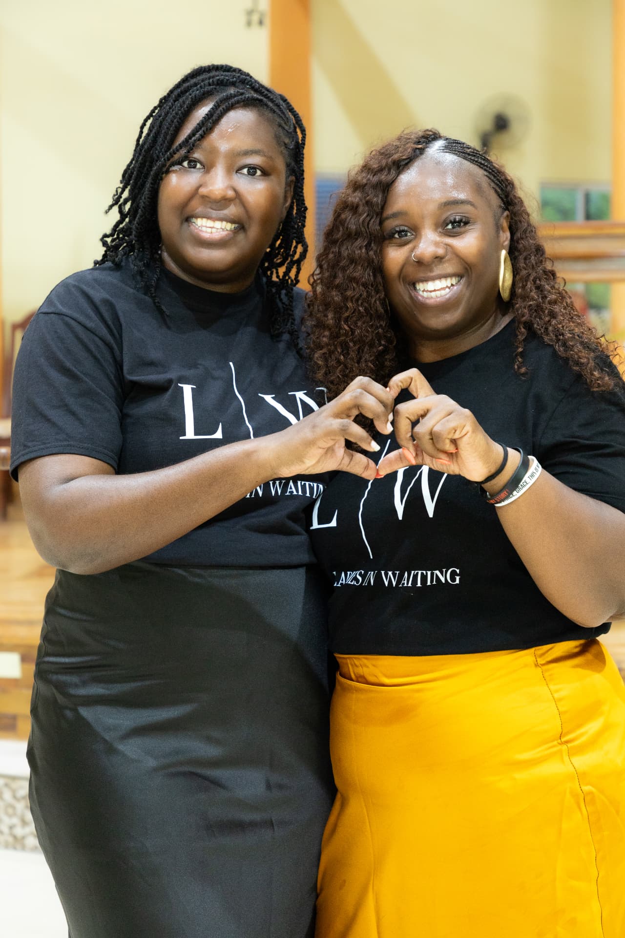 Two LIW Jamaica team members making a heart sign with their hands