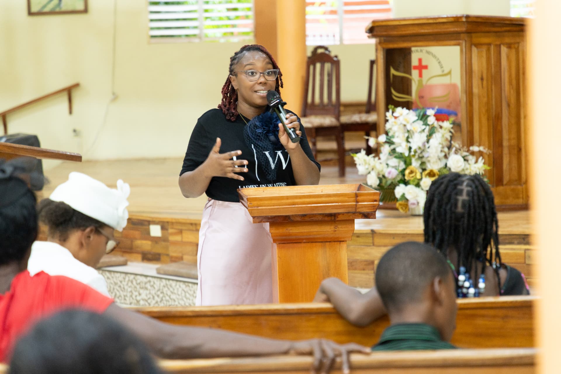 The LIW Jamaica speaker gesturing expressively while presenting from the podium