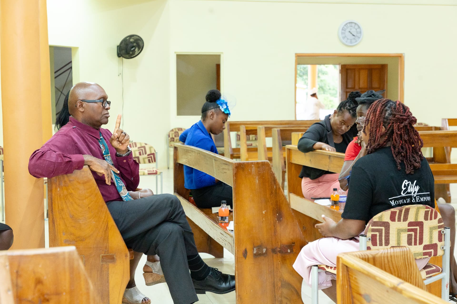 Attendees in small groups talking during the LIW Jamaica launch session